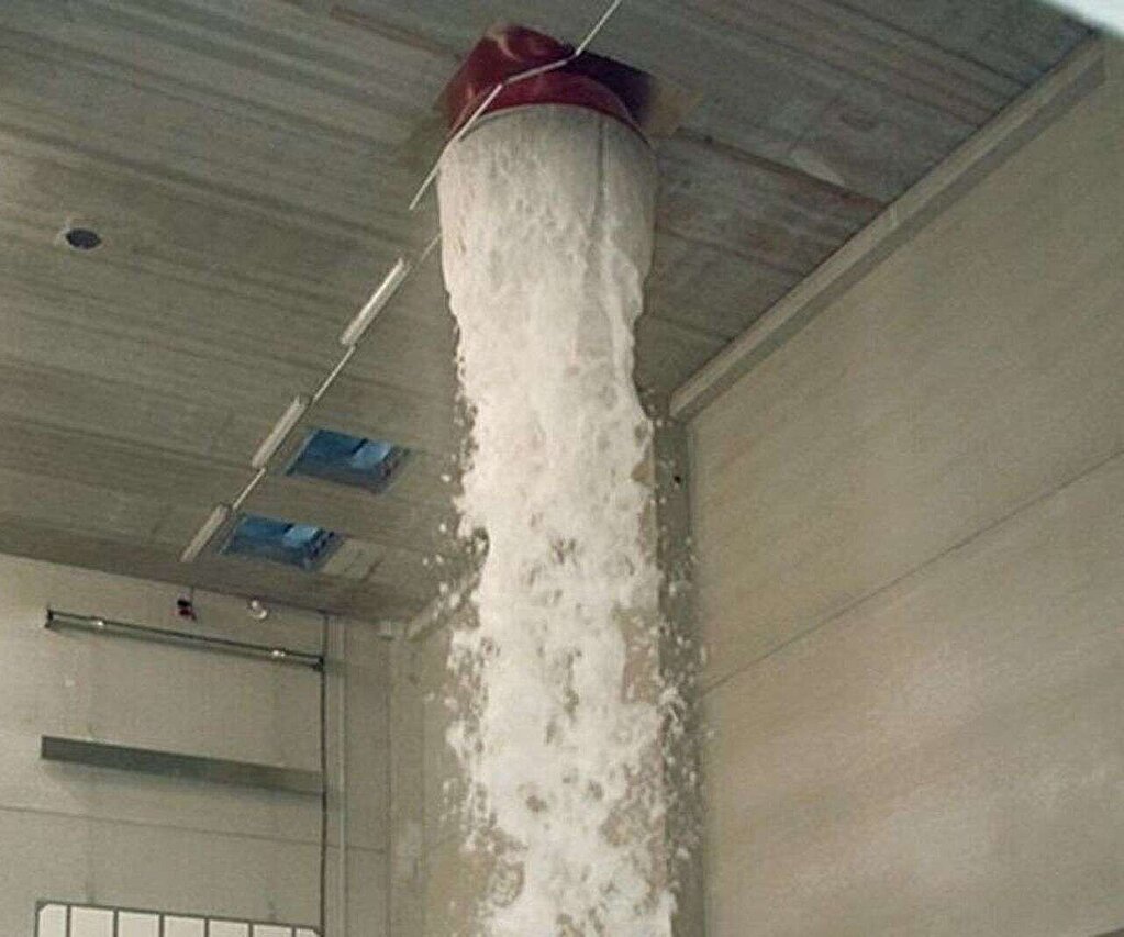 Foam flows from a supply line from the ceiling