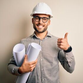 Engineer with 2 plans shows thumbs up